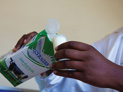 A scientist measures milk ready for testing. Common laws could ease movement of skilled personnel across the region and enhance service delivery, especially in countries that lack ....
