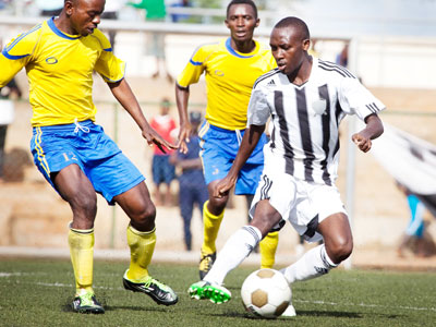 APR's Tumaine Ntamuhanga shields the ball from AS Muhanga's midfielder Hamad Uzabakiriho in yesterday's Peace Cup match at Kigali Regional Stadium. (Timothy Kisambira)