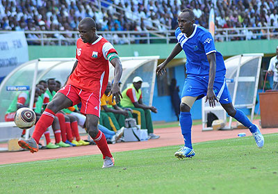 Musanze skipper Omar Hitimana controls the ball as Rayon Sports rightback Karim Nizigiymana closes in during a past league match last season. File.