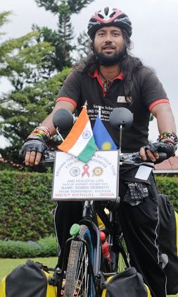Somen Debnath has embarked on a 200,000km bicycle ride aimed at rising awareness against HIV/Aids. Inset, the HIV/Aids activist crosses the Gatuna border.  Clement  Uwiringiyimana.  