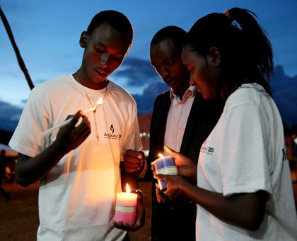 Youth light candles at a Genocide commemoration event in Kigali. Timothy Kisambira.