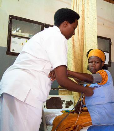 A nurse attending to a patient at Rwanda Military Hospital - Kanombe / Timothy Kisambira.