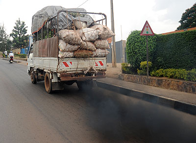 A cargo truck emits half-combusted exhaust gas. Timothy Kisambira.