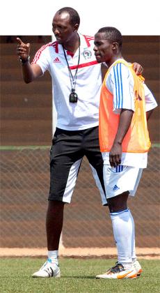 Incumbent Amavubi coach Eric Nshimiyimana, seen here giving instructions to striker Michel Ndahinduka, during a previous training session. T. Kisambira