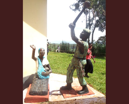 A statue erected near the entrance of the Mibilizi memorial site depicting a militia killing a woman, while below right, the Mibilizi church whose backyard was defaced with human b....
