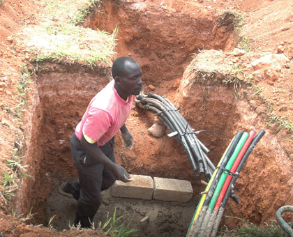 A worker lays fibre optic cables. Rwanda has invested in broadband infrastructure, including the laying of fibre optic cables across the country. File.