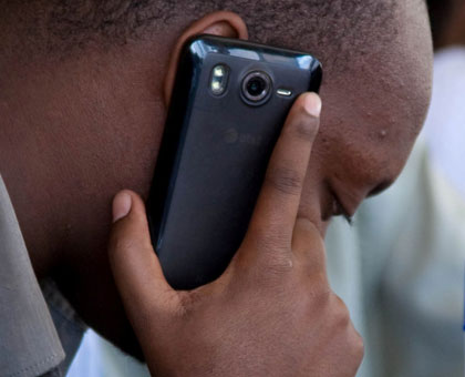 A man speaks on a mobile phone. T.Kisambira