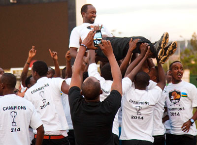 APR head coach Vincent Mashami is lifted in the air by players after winning the Turbo King Football League title on Sunday. Timothy Kisambira.