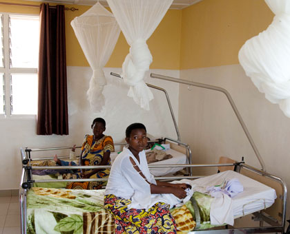 Mothers rest on hospital beds furnished with mosquito nets in Matyazo Maternity Ward in Huye District. Timothy Kisambira.