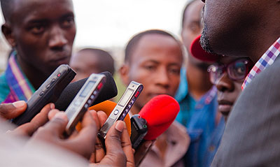 Journalists interview a source at the Kigali Regional Stadium over the weekend. Timothy Kisambira. 