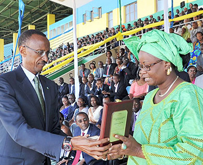 President Kagame hands a posthumous medal for Capt. Mbaye Diagne to his widow during the 16th Liberation Day celebrations in Kigali in 2010. The UN Security Council yesterday created u2018the u2018Captain Mbaye Diagne Medal for Exceptional Courageu2019 in honour of a peacekeeper credited with saving lives in the 1994 Genocide against the Tutsi. File.