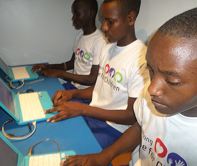 Students at the solar powered Groupe Scolaire Kamabare school use the computers. T.Kisambira. 