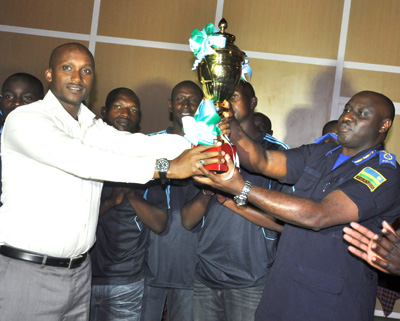 IGP Emmanuel K. Gasana (R) receiving the Labour Day trophy from Club chairman, Donald Kabanda. Courtesy