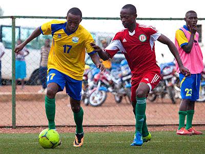 Striker Maxime Sekamana seen dribbling past a Burundian defender in a past friendly match will be key for Rwanda when they host Gabon this afternoon in Kigali. (Timothy Kisambira)
