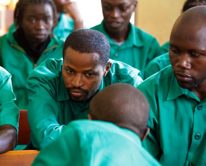 Lt. Mutabazi (centre)  speaks to his co- accused at Nyamirambo military court last year. File  File. 