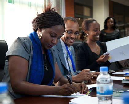 State Minister for Energy and Water Emma Francoise Isumbingabo ( L), and  EWSA chief Ntare Karitanyi,  sign the agreements between the government and the investors yesterday. Timothy Kisambira.