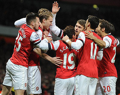 Arsenal players celebrate their first goal of the game during their 2-0 win over Hull in Premier League