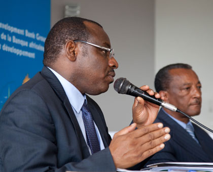 Finance minister Gatete addresses journalists on Thursday as AfDB's country representative Negatu Makonnen looks on. Timothy Kisambira