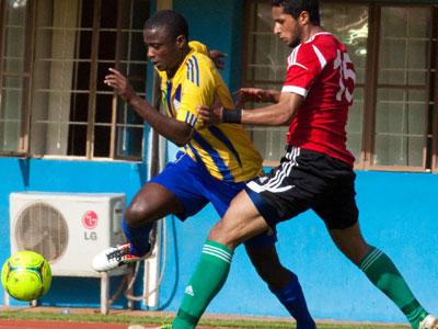 Striker Elias Uzamukunda seen against a Libya defender in March last year. He will lead an offensive for Amavubi as they seek a bright start to the 2015 Africa Nations Cup qualifie....