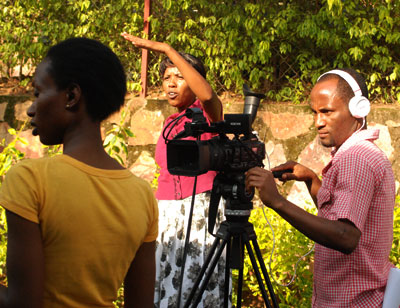 One of the beneficiaries, Espu00e9rance Uwimana (centre) directing her film.