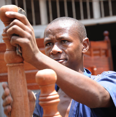 A young entrepreneur works on his furniture in a Kigali workshop. Governments have been urged to create enabling environments that are conducive for entrepreneurial ideas. John Mbanda. 