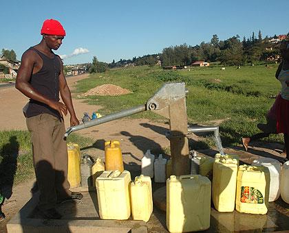 People fetch water from a borehole in Gacuriro in Kigali. Governments have the responsibility to provide clean water. (File)