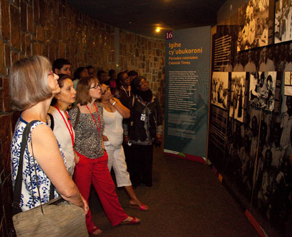 Visitors look at pictures of Genocide victims at Kigali Genocide Memorial Centre in Gisozi. Timothy Kisambira.