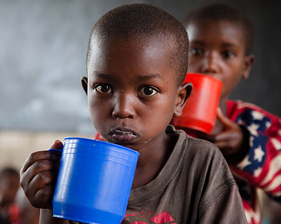 Children in Kigeme Refugee Camp eating Porridge in the recent past.  Timothy Kisambira. 