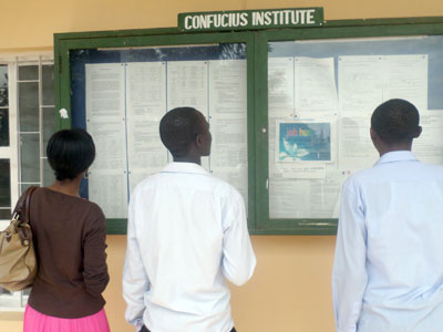 Students check out for their results on the notice board. (Solomon Asaba)