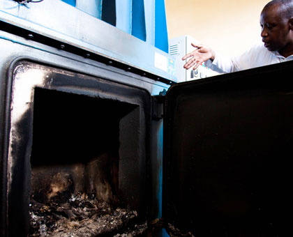 A technician checks the incinerator at University Teaching Hospital of Kigali. (Timothy Kisambira)