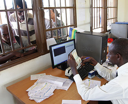 A Rwandan migration officer at work at Nemba border post. (John Mbanda)