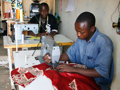 Tailors sewing clothes. Guy Rider, the IL0 director-general said Quality jobs are a prerequisite for development. (Timothy Kisambira)