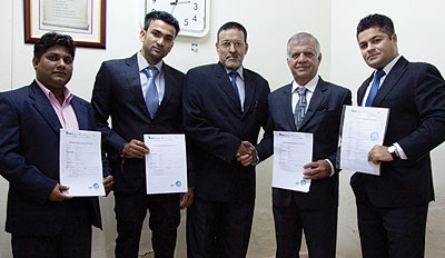 Fernandes (middle) poses for a photo with the four investors as they display their RDB registration certificates. The investors have interests in the education, ICT and health sectors. The New Times/ Timothy Kisambira 