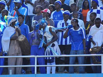 Rayon Sports cheer leader Rwarutabura (C), who holds a Rwf5000 membership card, leads fellow supporters during a league match last season. (File)