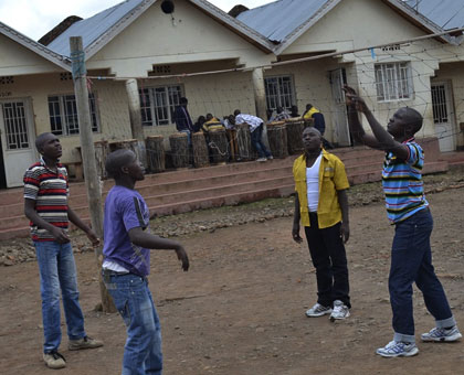 Some of the former child soldiers (foreground) play volleyball as their colleagues in the background play board games at Muhoza ex-Child Combatant Centre in Musanze District.   Jean du2019Amour Mbonyinshuti.