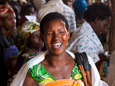 A refugee woman in Kigeme camp smiles after receiving clothes from Risd, a local non-governmental organisation. Joint efforts by government and NGOs have helped restore dignity among refugees. (Timothy Kisambira)