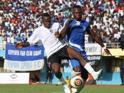 APR winger Charles Tibingana Mwesigye battles with Rayon Sports defender Hussein Sibomana during the league clash this season. (File)