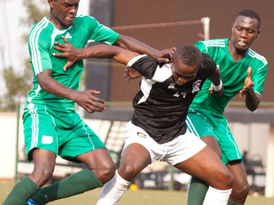 APRu2019s Michel Ndahinduka shields the ball against two Kiyovu defenders Hussein Habimana and Alexis Ngirimana in yesterday game. (Timothy Kisambira)