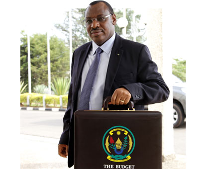 Finance minister Claver Gatete arrives at Parliament Buildings to present the 2014/2015 National Budget yesterday. John Mbanda.