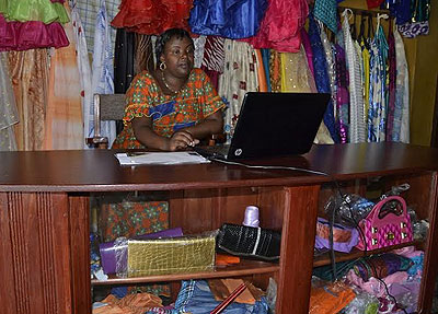 Uwimana uses a laptop in her shop. She runs a successful business despite the bad beginning. Jean du2019Amour Mbonyinshuti.