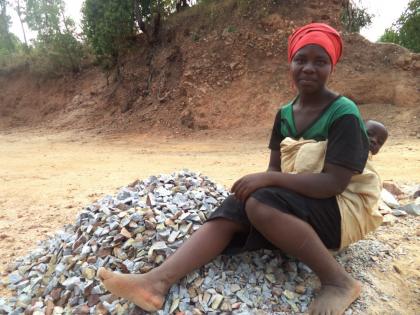 Musabyimana at a stone quarry with her baby. Breaking stones into gravels is her only source of livelihood.   Jean Pierre Bucyensenge.