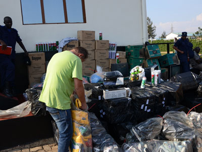 Oelof Duplooy, the Nike brand investigator in Africa checks the impounded counterfeit products, at Police headquarters in Kacyiru on Tuesday. (Samuel Ngendahimana)