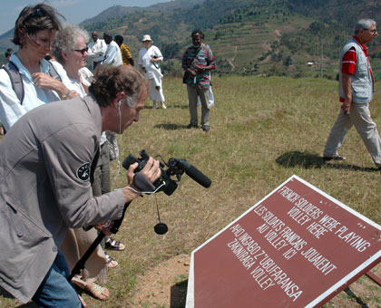 Bruno Vienne, a French cameraman, films a place where French soldiers used to play volley ball during Opu00e9ration Turquoise, when he visited Murambi Genocide site in June 2009. John Mbanda. 