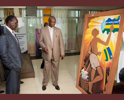 Trade and Industry minister Francois Kanimba (L), looks at one of the art pieces on display during the Craft awards at Lemigo Hotel on Friday. Timothy Kisambira.  