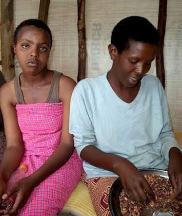 Uwajeneza Kadogo(L), sits next to her mother Feza Nyirakamana. The teenager was denied a chance to study because of the instability that has plagued her homeland, and separated from her father.  Jean Pierre Bucyensenge 