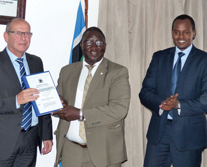 Michel Fest, the director of Gauff Ingenieure consultants (L), Ugandau2019s Permanent Secretary in the Ministry of Works and Transport Okello Bwangamoi (C) and Guy Kalisa, the director-general of Rwanda Transport Development Agency, after signing the contract in Kampala yesterday. Gashegu Muramira.