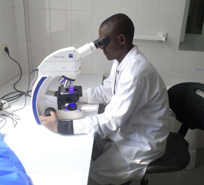 A lab technician screens for TB at Gicumbi Hospital. Ivan Ngoboka. 