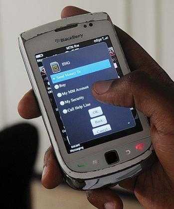A subscriber uses a phoneu2019s mobile money service to send money. The service can be used by banks to mobilise and grow their deposits if they partner with telecoms. The New Times / File photo.  