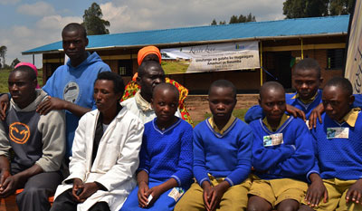 Some of the pupils  and their parents in front of  the classroom block launched in Nyabihu yesterday. J. du2019Amour Mbonyinshuti. 