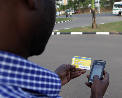 A man recharges his telephone account. Telecom companies are likely to increase calling rates following an increase in excise duty on airtime. File.